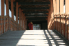 Monk Walking Over Bridge